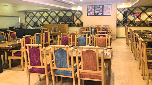 seating arrangments inside a restaurant with the lights switched on - Raj Park Hotel, Tirupati
