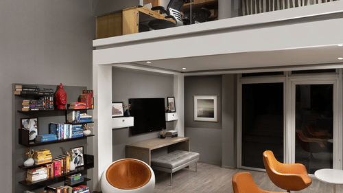 A spacious, modern multi-level living area at The Atara, Gurugram features an upper mezzanine level, a large bookshelf, a comfortable sofa, and a stylish armchair, creating an open design