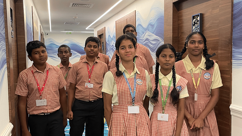 A picture featuring a group of students walking in the lobby