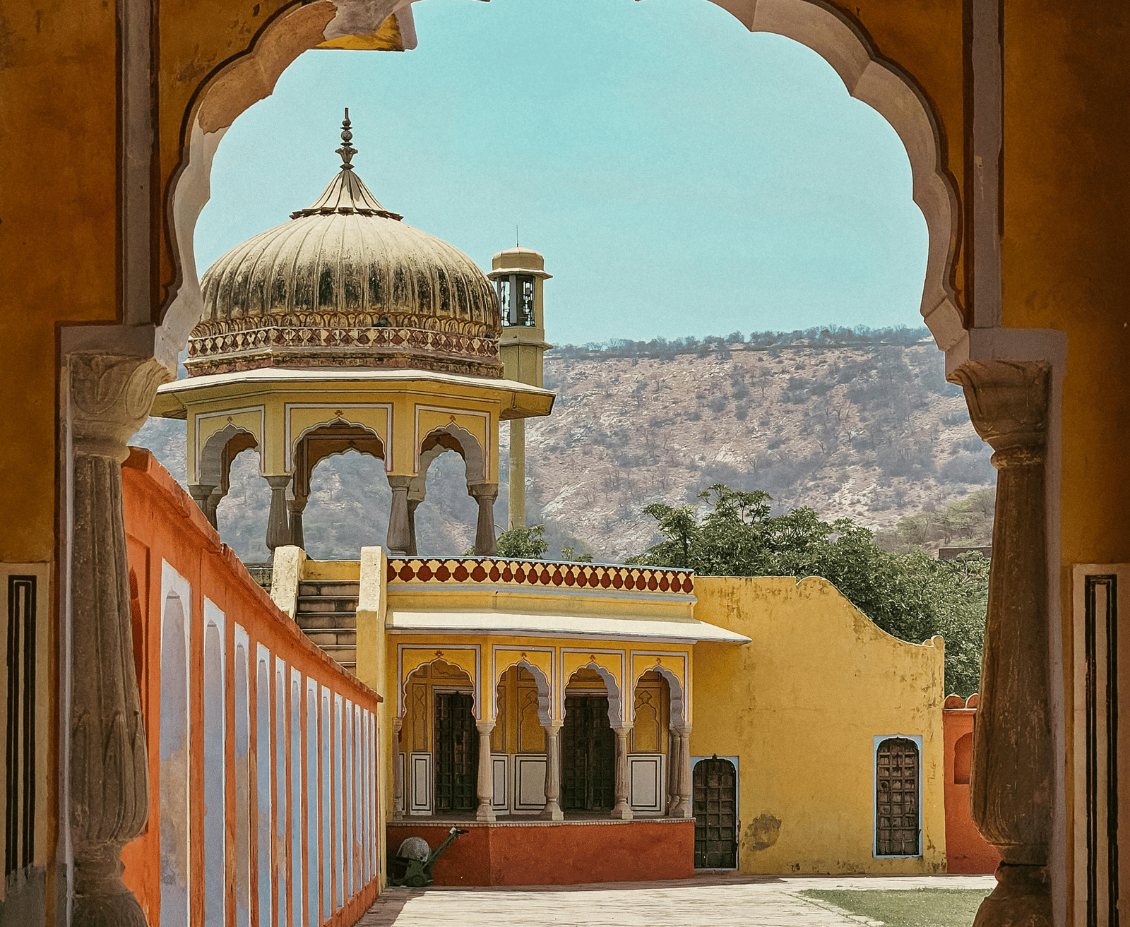Arched doorway opening to courtyard and traditional architecture