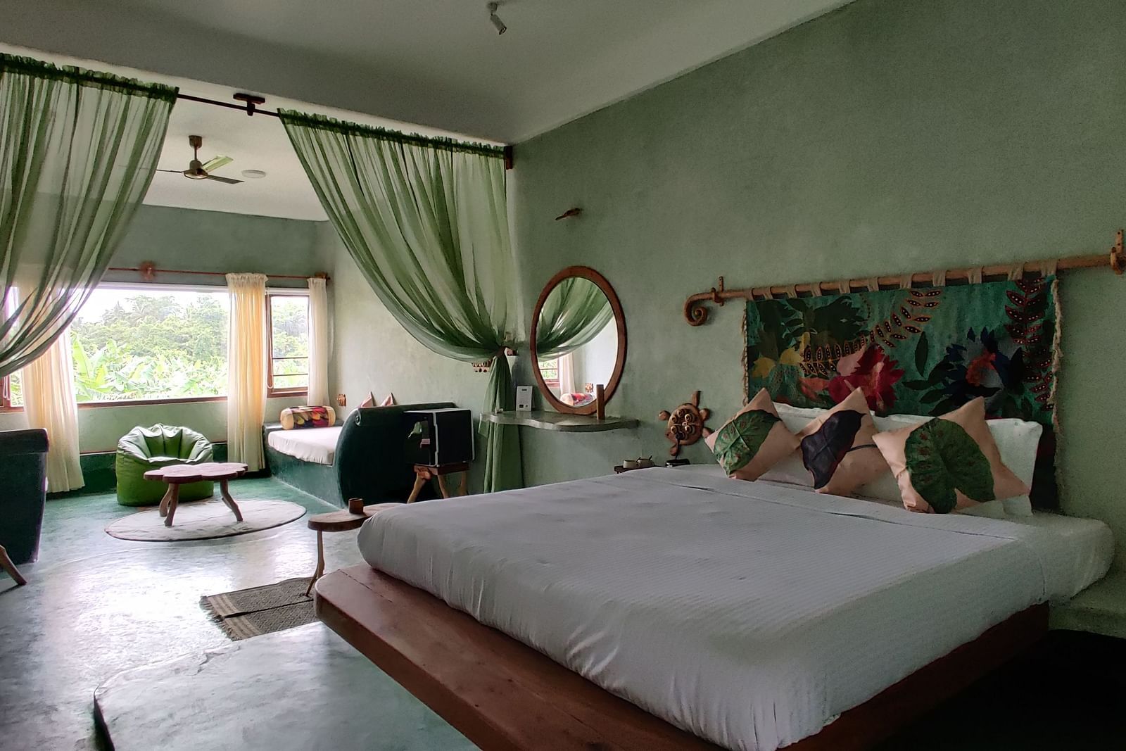 Bed in the room beside a living room | Matsya Island Retreat