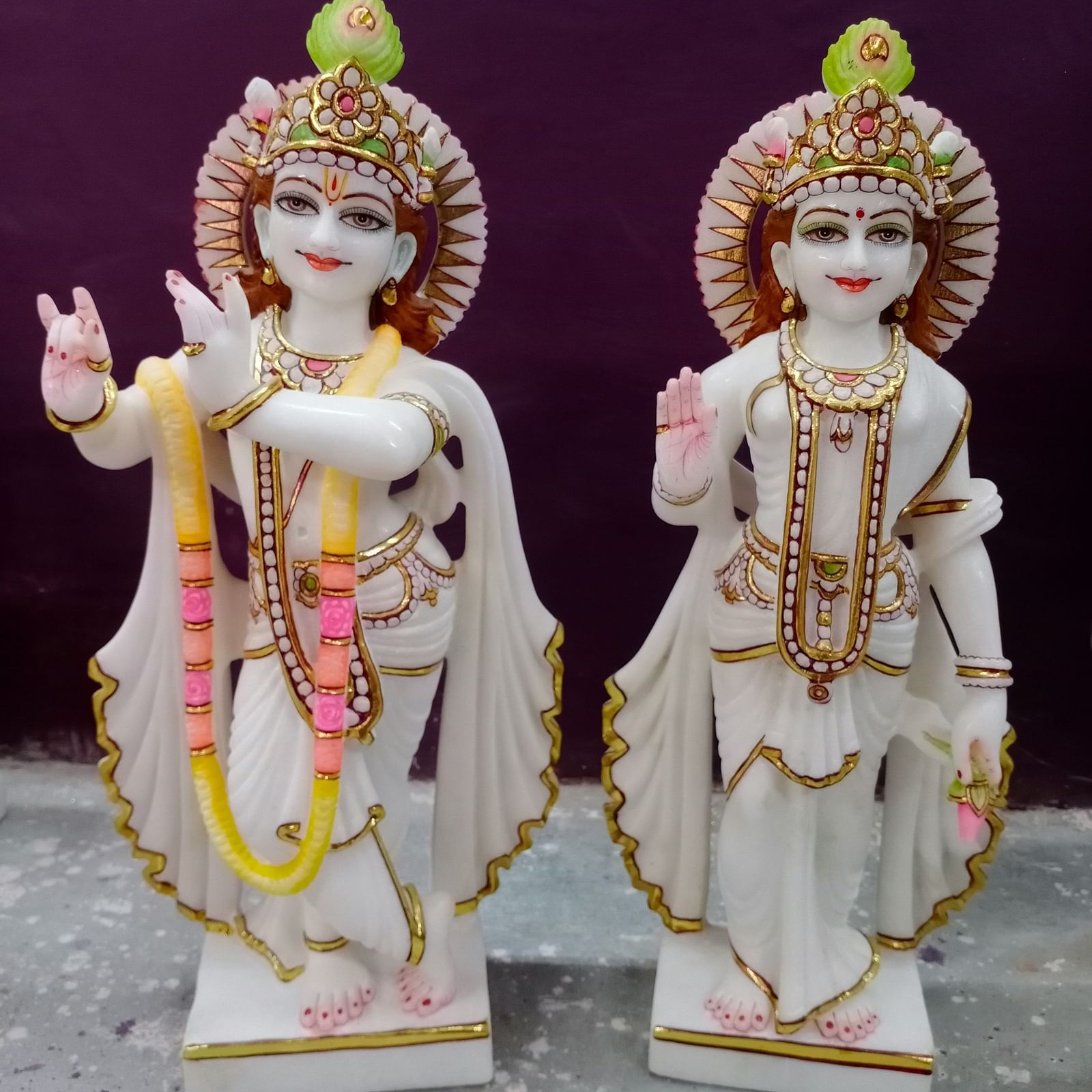 Porcelain idols of deities with garlands around the neck