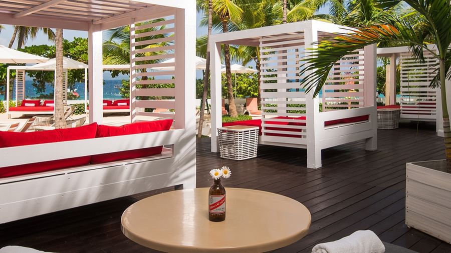 An outdoor seating area attached to our rooms offering cabanas and cushioned chairs for comfort - S Hotel Montego Bay, Jamaica