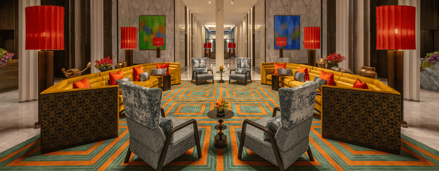 Lobby lounge area with colourful seating and decorative lantern lighting at The Residency Signature Madurai.
