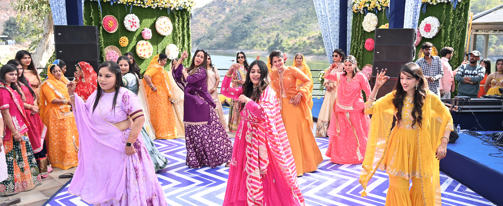 Bridesmaids dancing in colourful dresses - Via Lakhela Resort & Spa