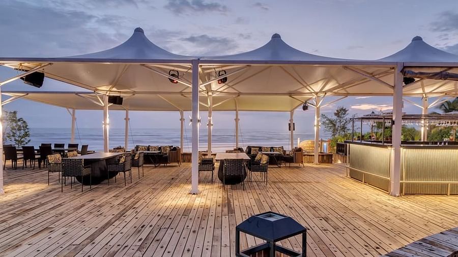an outside cabana seating arrangement overlooking the beach - Mayfair On Sea, Morjim, Goa