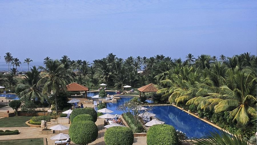 An aerial view of the pool, lawns and thick vegetation at Kenilworth Resort and Spa which is considered as one of the best resorts in Goa with private beach