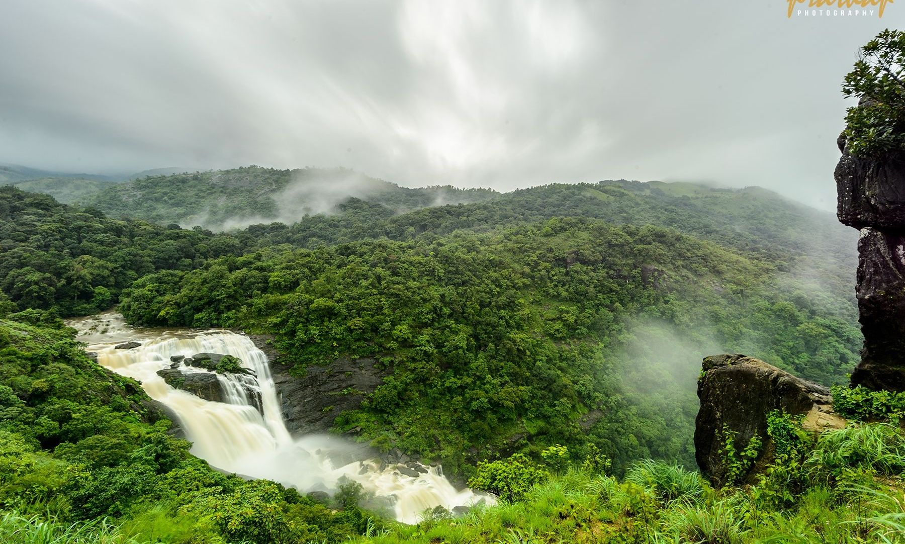 Mallalli Falls, Coorg, amidst misty mountains.