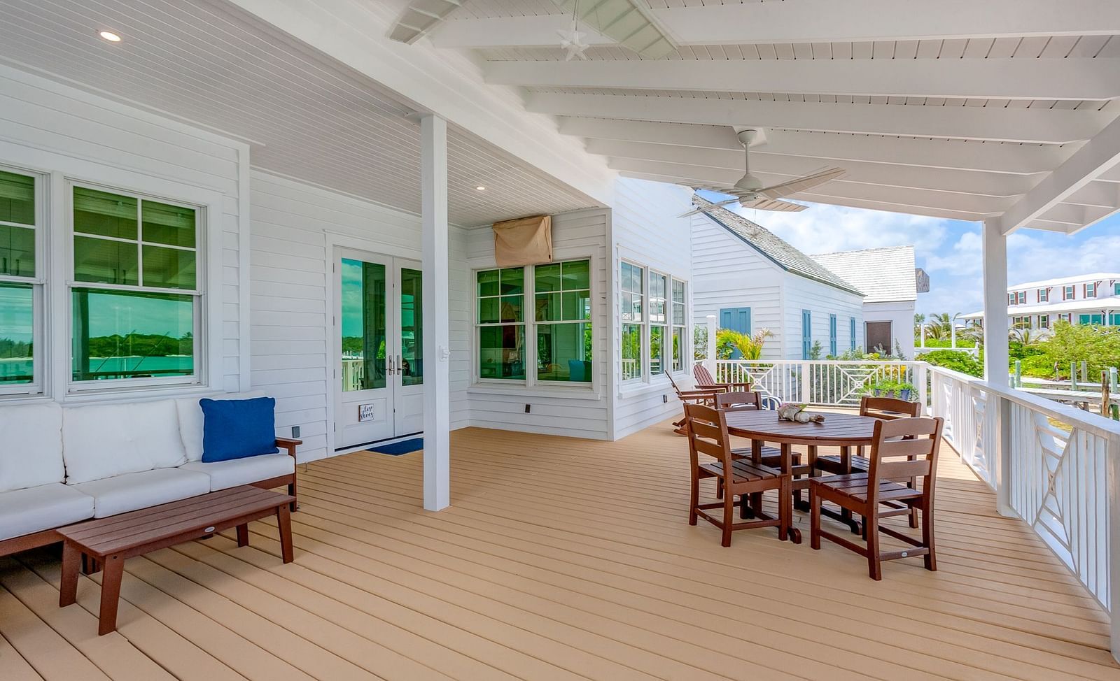 Covered outdoor dining area on a wooden deck overlooking the waterfront | Abaco Inn