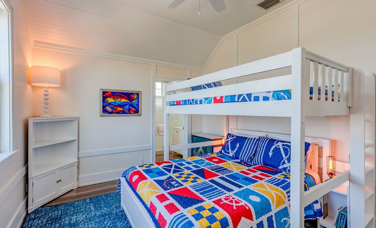 Children's bedroom with a white bunk bed and colorful bedding | Abaco Inn