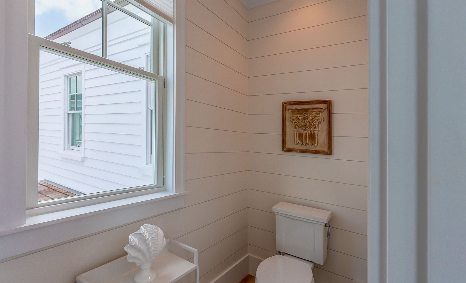 A washroom with white walls and a toilet at Abaco Inn.