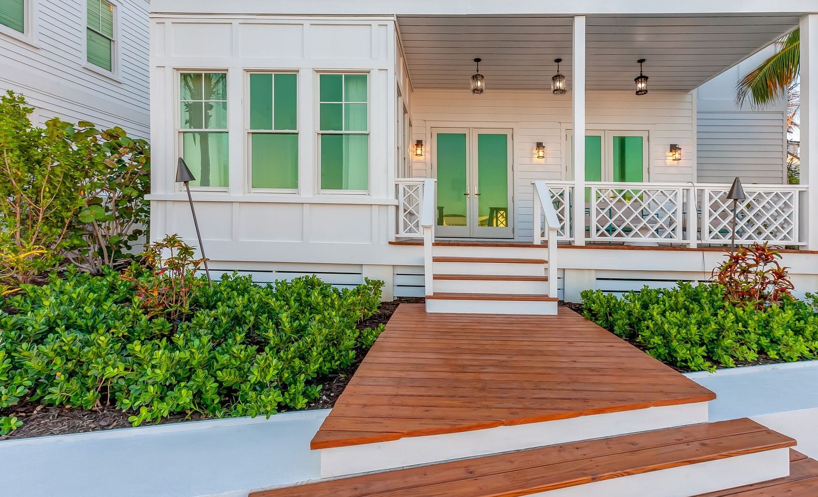Facade of Abaco Inn with wooden dock and greenery.