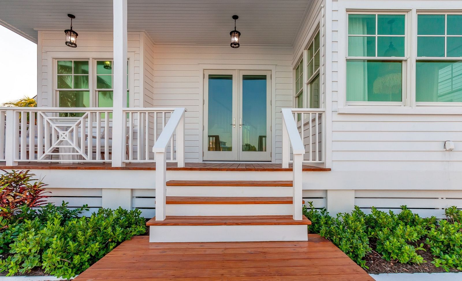 Facade of Abaco Inn with wooden dock and potted plants. 