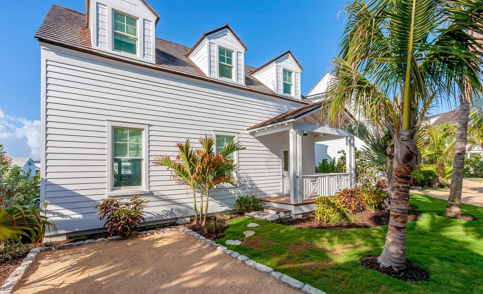 Facade of Abaco Inn with greenery and palm trees.