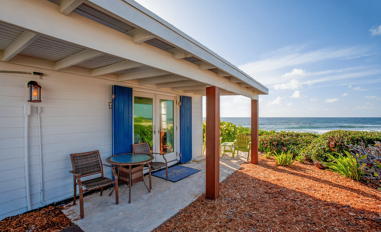 Porch with chairs outside a white villa near the coast | Abaco Inn