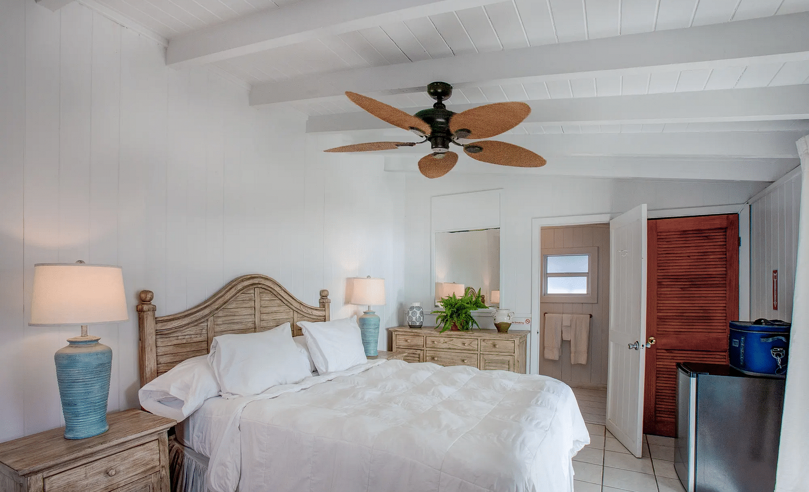 Bedroom with two beds, ceiling fan, and warm lighting | Abaco Inn