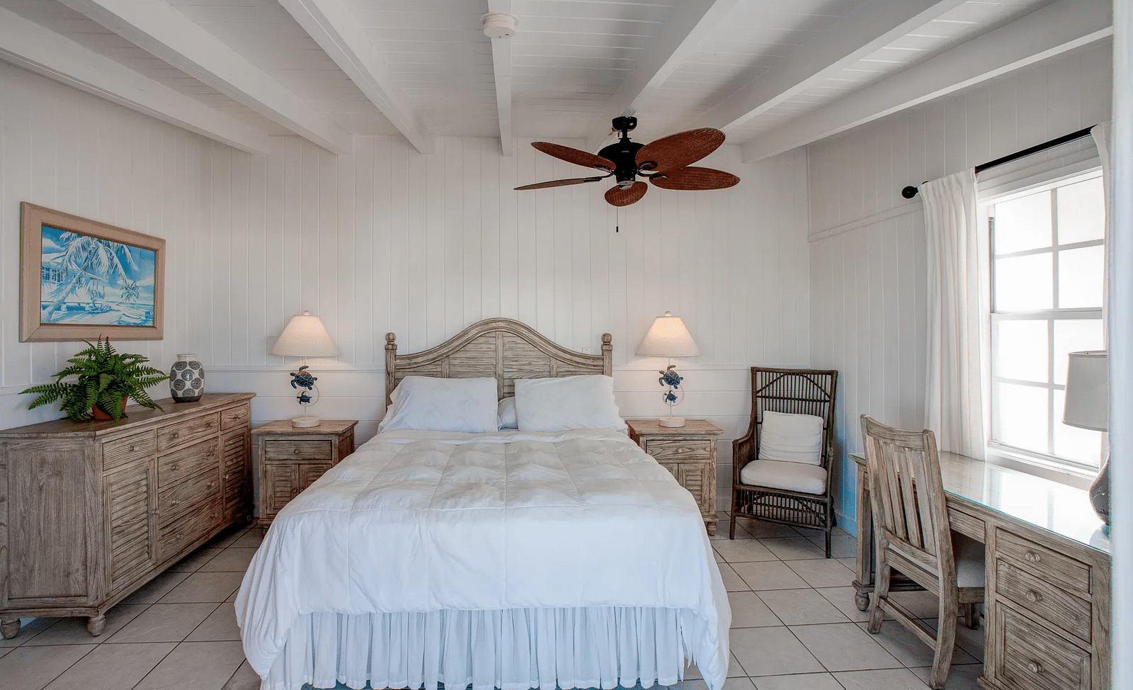 Bedroom with a double bed, ceiling fan, and natural light | Abaco Inn