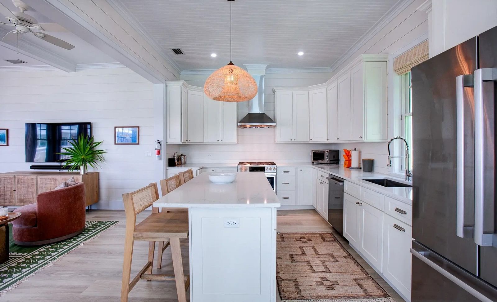 Open kitchen with a central island, bar stools, and modern appliances | Abaco Inn