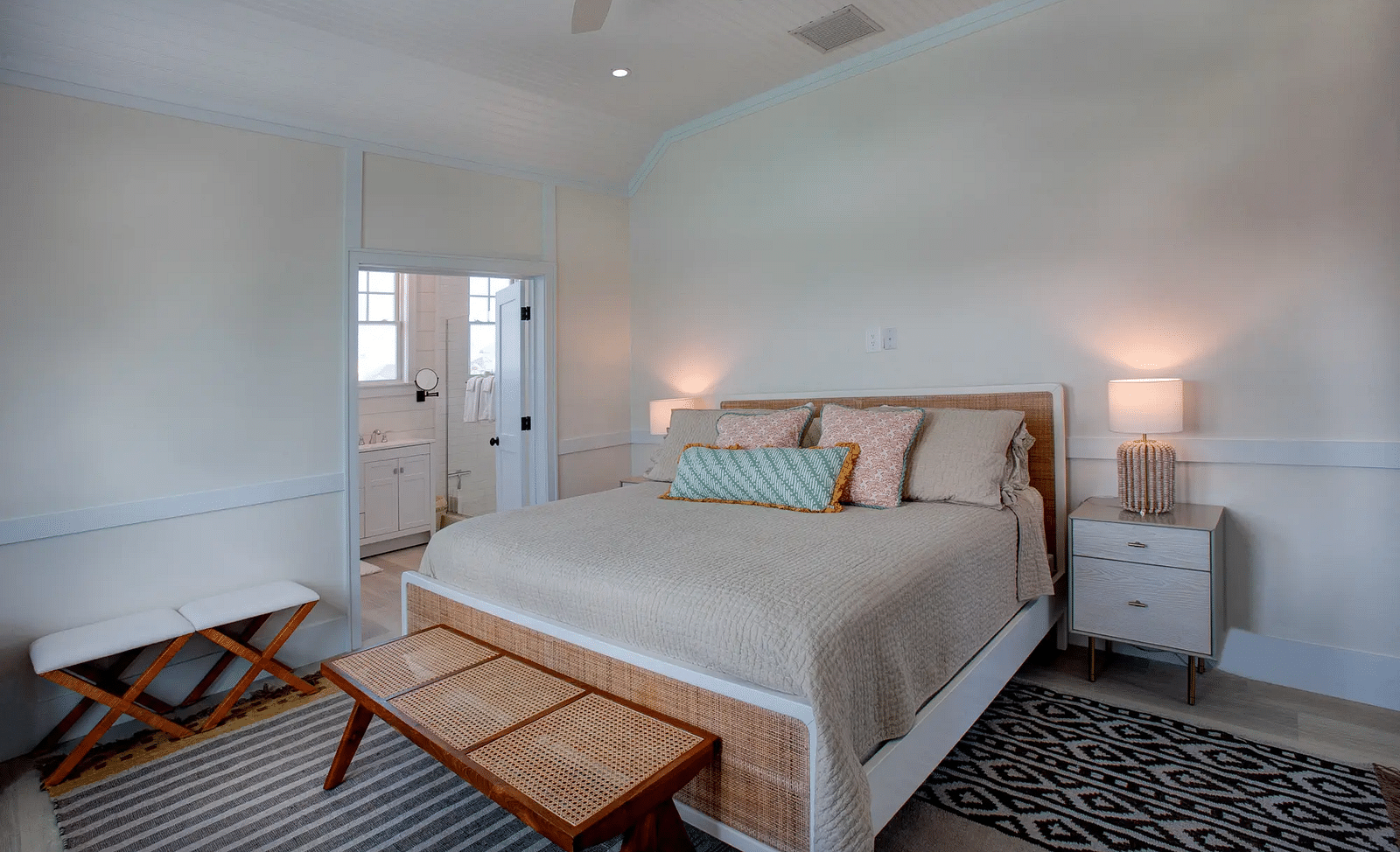 Bedroom with a simple bed, wooden bench, and white walls | Abaco Inn