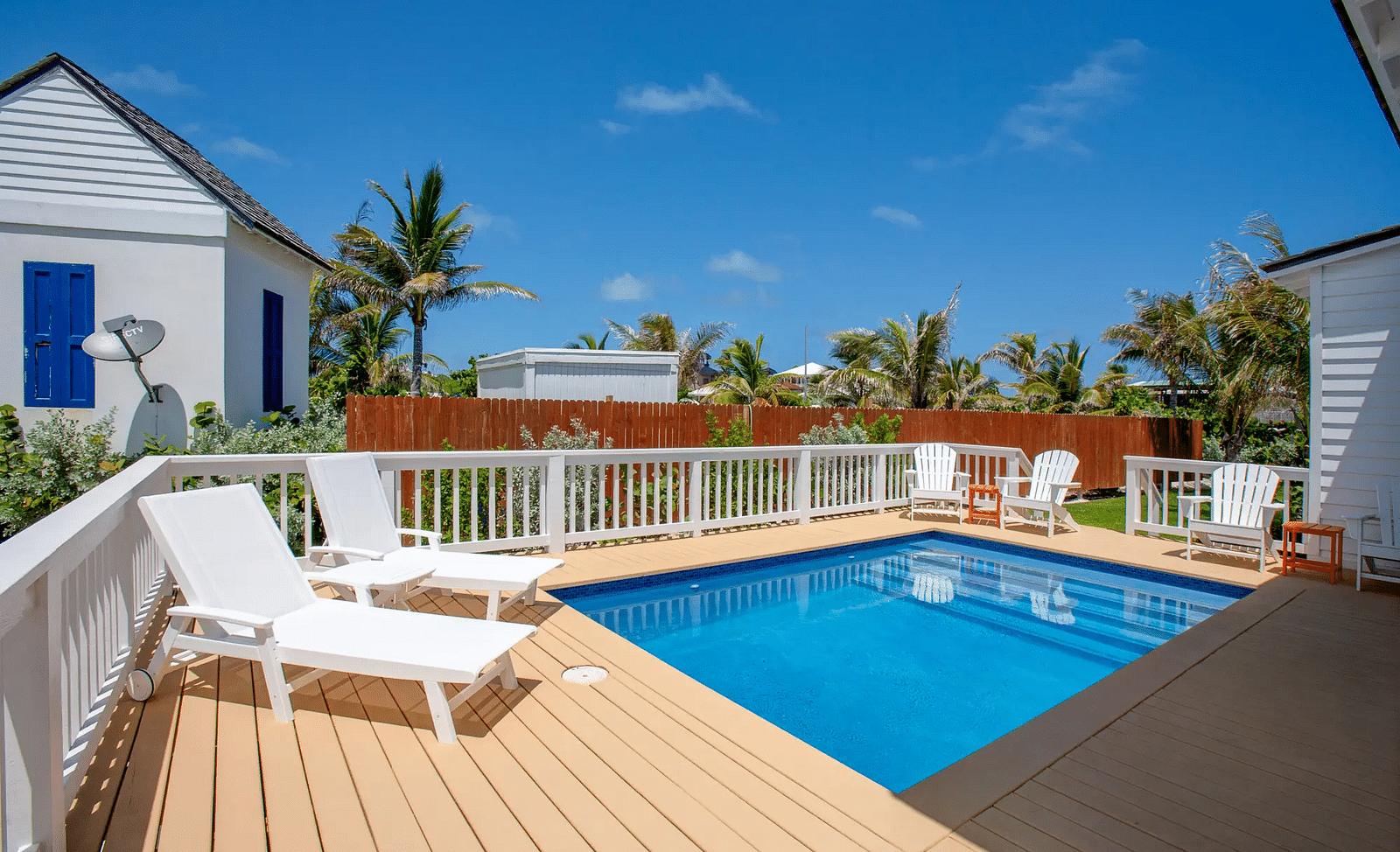 Outdoor deck with a private pool and white lounge chairs | Abaco Inn