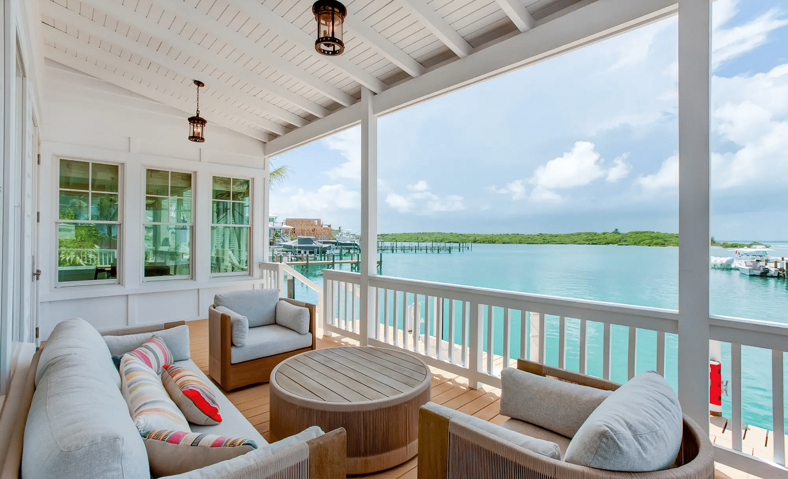 Outdoor seating area on a covered deck overlooking the water | Abaco Inn