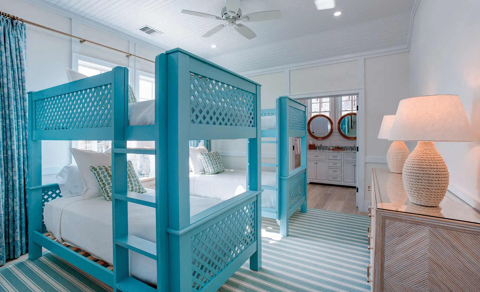 Bedroom with blue four-poster beds and striped carpet | Abaco Inn