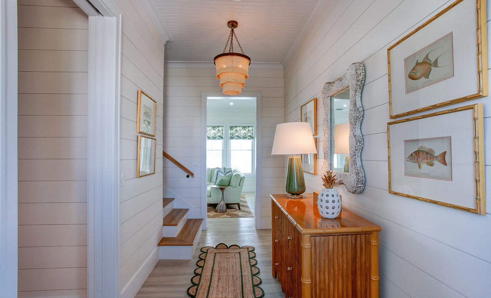 Hallway with wooden console table, framed artwork, and coastal decor | Abaco Inn