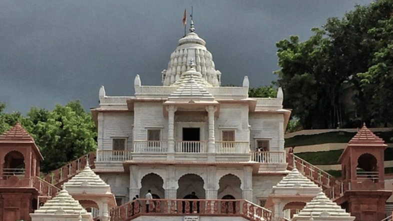An exterior view of the Shree Gajanan Maharaj Mandir, bustling with visitors as they come to offer their prayers and seek blessings.