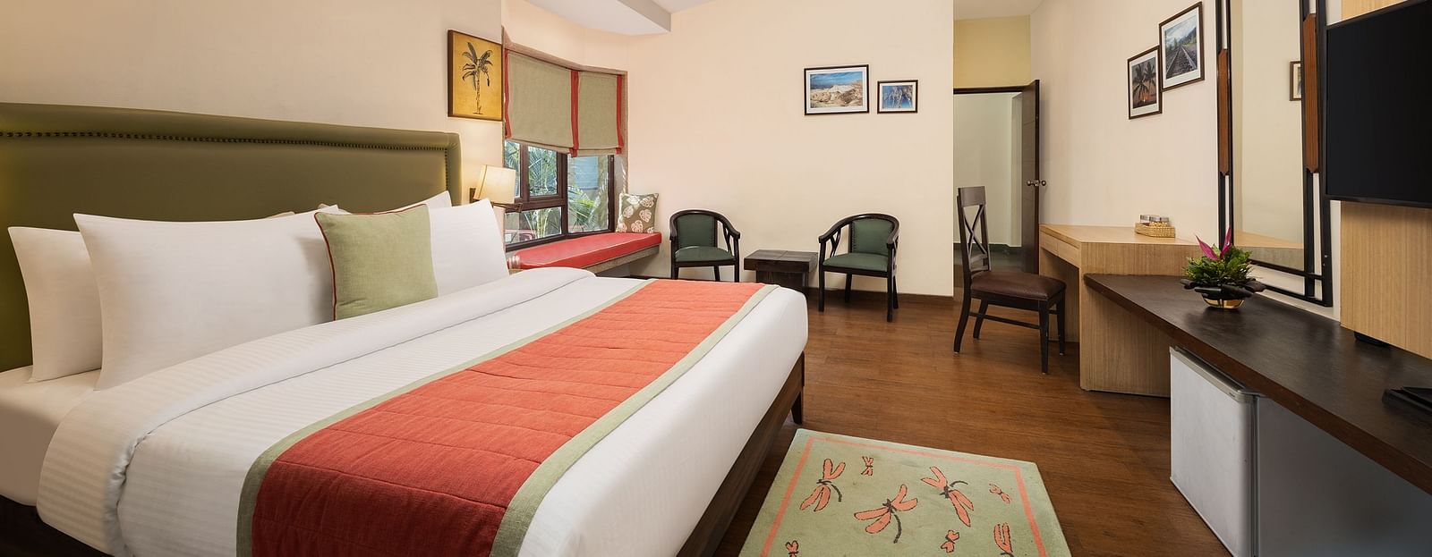 Luxurious hotel room with king-size bed, olive-green leather accents, TV, mirror, lamps, and seating for 2-3 - The Riverview Retreat, Corbett