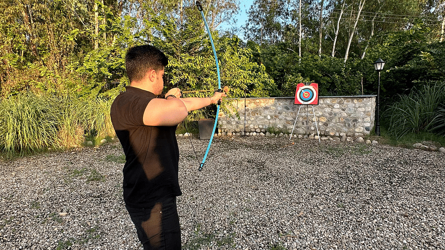 A person enjoying archery activity at our resort near Haridwar - Aalia Jungle Resort & Spa