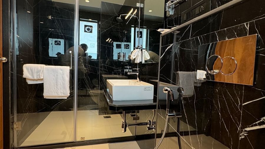 Overview of the bathroom with a glass door for the shower area inside luxury room - Hotel Mumbai House, Valnai, Malad