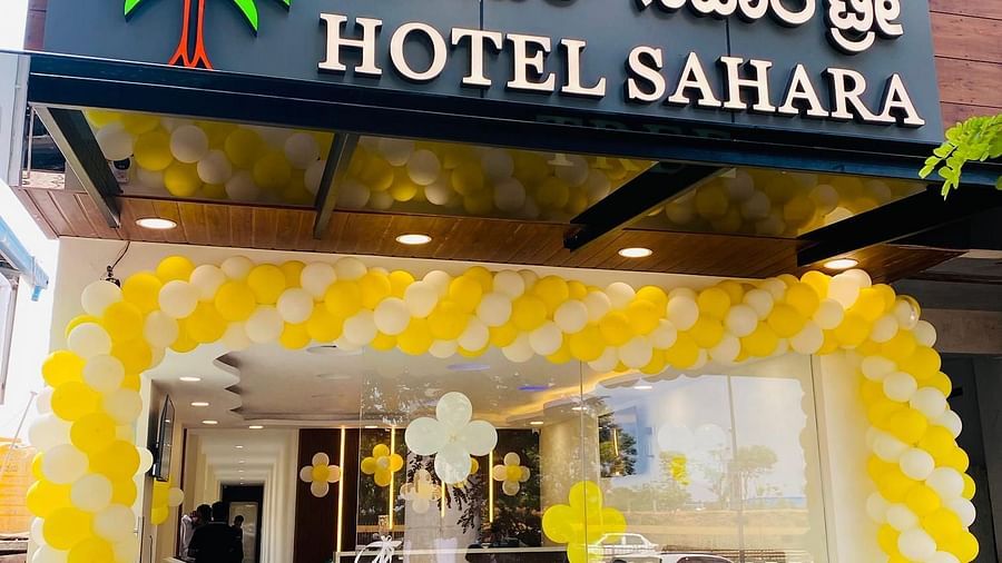 Entrance view with illuminated signage and welcoming entrance to Hotel Sahara Tree.