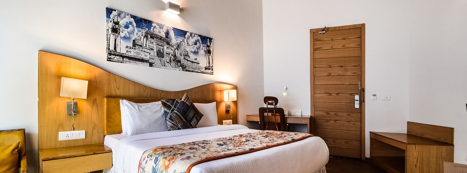A cosy room with a bed, wooden furniture, and a unique ceiling.- Bamboo Saa Resort & Spa, Udaipur
