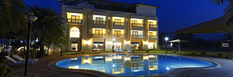 The nighttime view of the facade of our resort in Vailankanni featuring the swimming pool 70