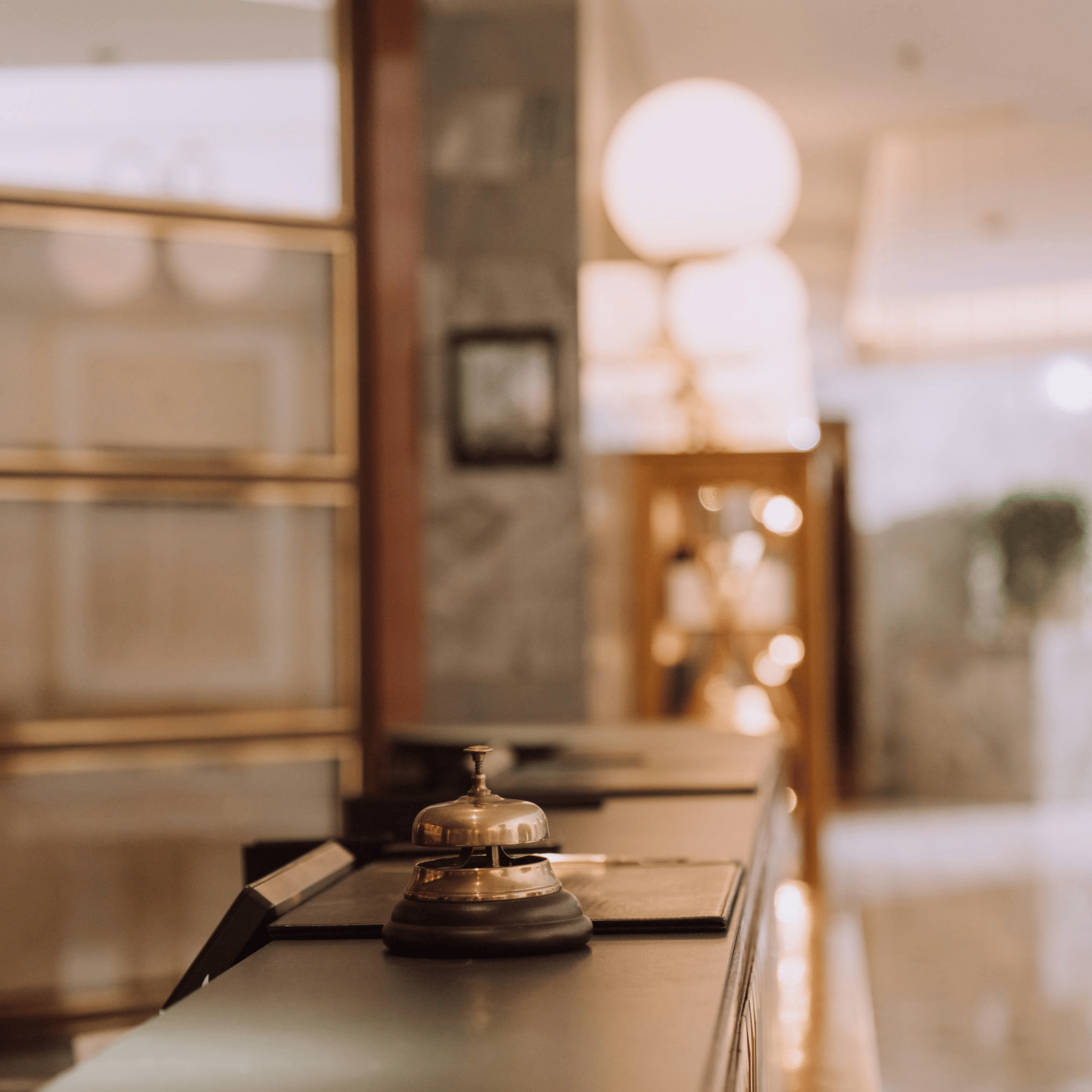 Close up shot of a concierge bell kept on a reception desk.
