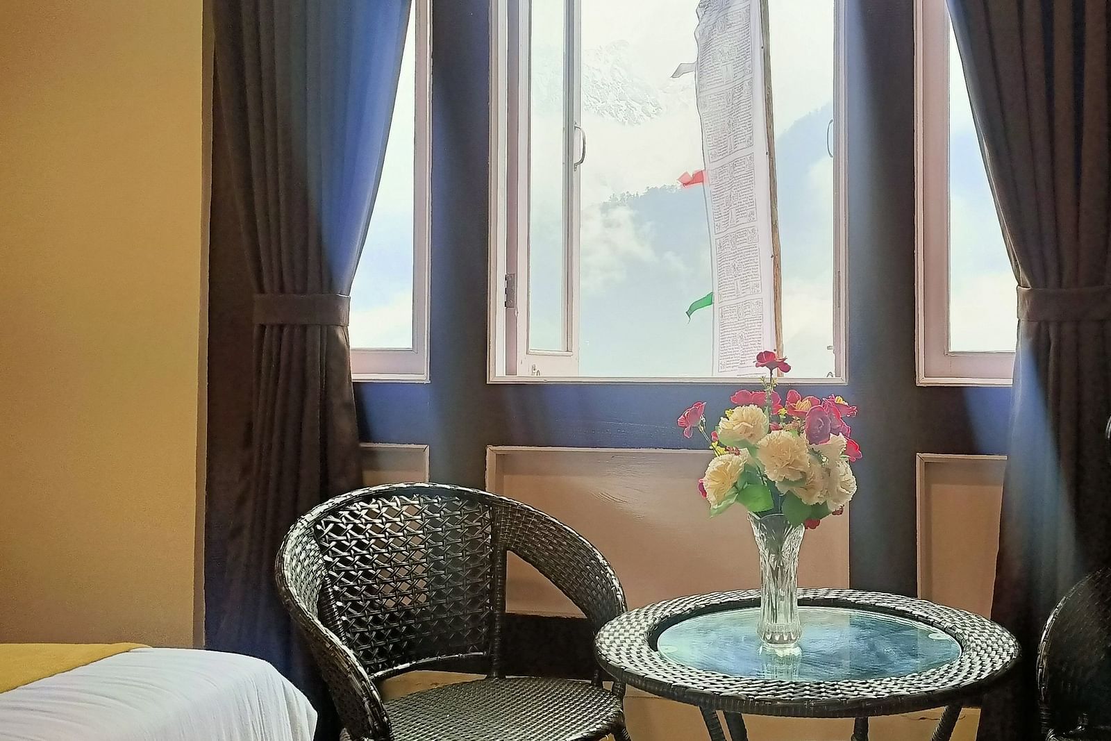 Deluxe Room at Ecotel Sonam Lachung decked with a chair and tea table