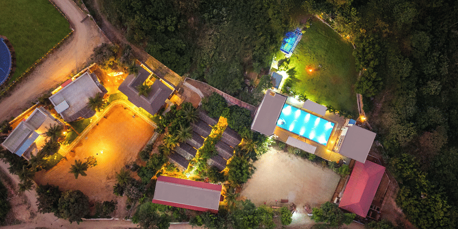 Clear top-down aerial view of the resort property, including the pool, courtyard, and building - 