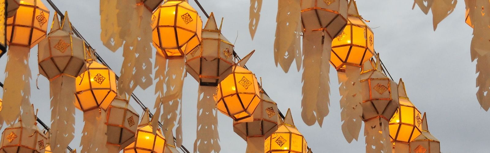 Many Handmade lanterns hung on a thread in a row to mark Loy Krathong