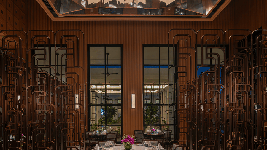 Chin Chin private dining room with a round table and lazy Susan, bronze lattice screens and a suspended folded-paper ceiling at The Residency Signature Madurai.
