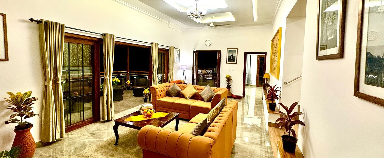 Tastefully furnished villa living area with artwork and access to the outdoors - BluSalzz Collection - Tranquil Resort, Wayanad