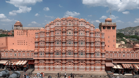 A large, intricate pink palace with many windows.