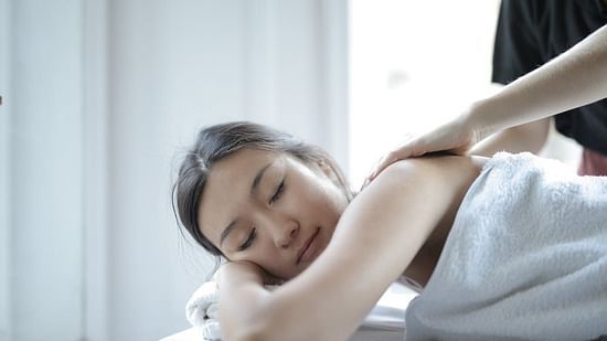 stock image of spa featuring a woman receiving back massage