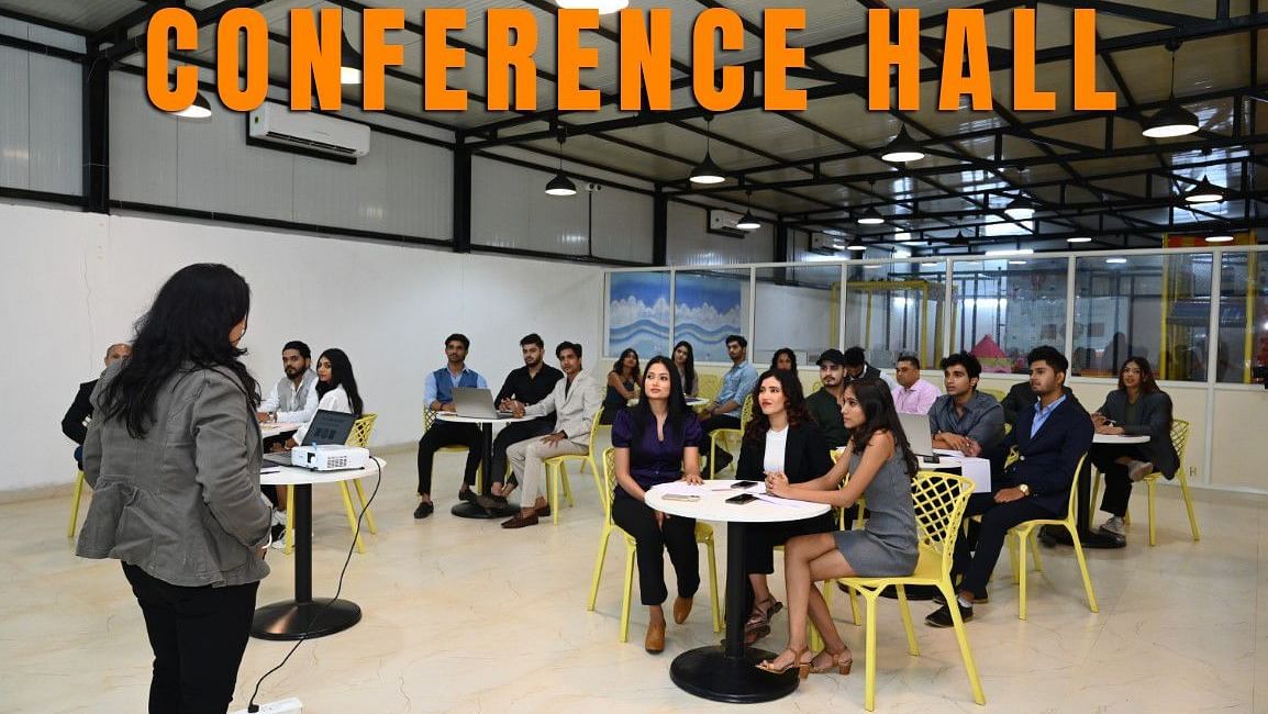 Conference Hall at Diamond Parks, Pune – Guests are seated in a modern indoor venue, attending a talk or meeting as part of a corporate or group event.