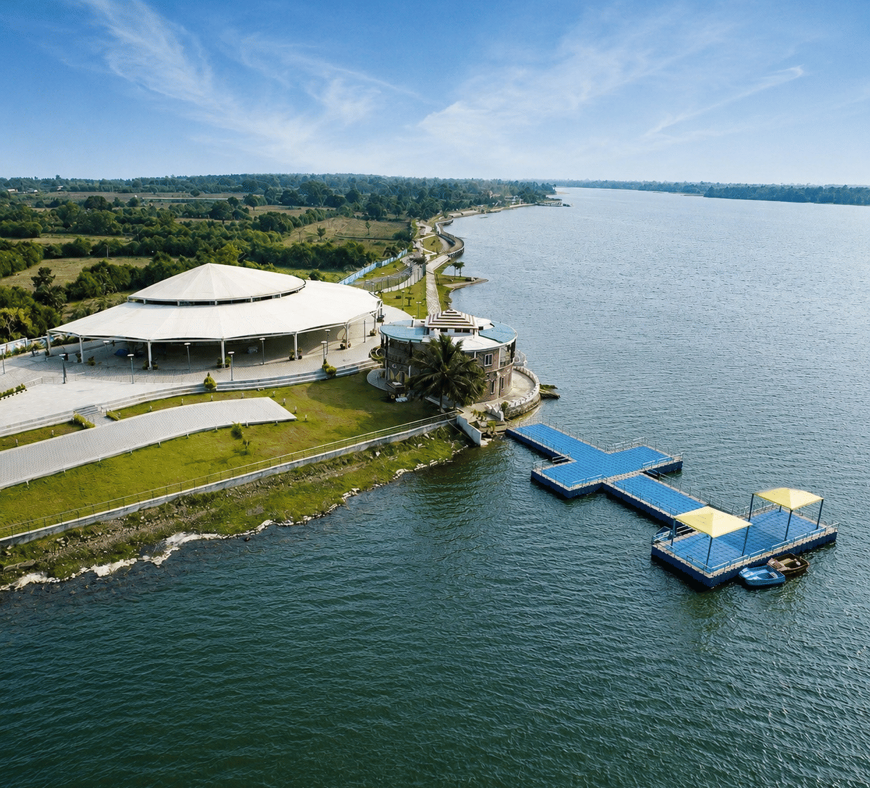 Tampara Lake with a white canopied pavilion, lakeside promenade, blue floating jetty and pedal boats, near MAYFAIR Palm Beach Resort, Gopalpur-on-Sea.