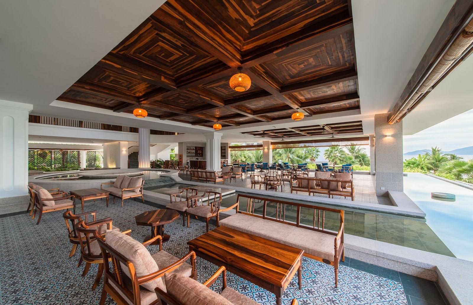 Another view of a restaurant at our hotel with comfortable seating arrangement and lamps hanging from the ceiling floor - Alibu Resort Nha Trang