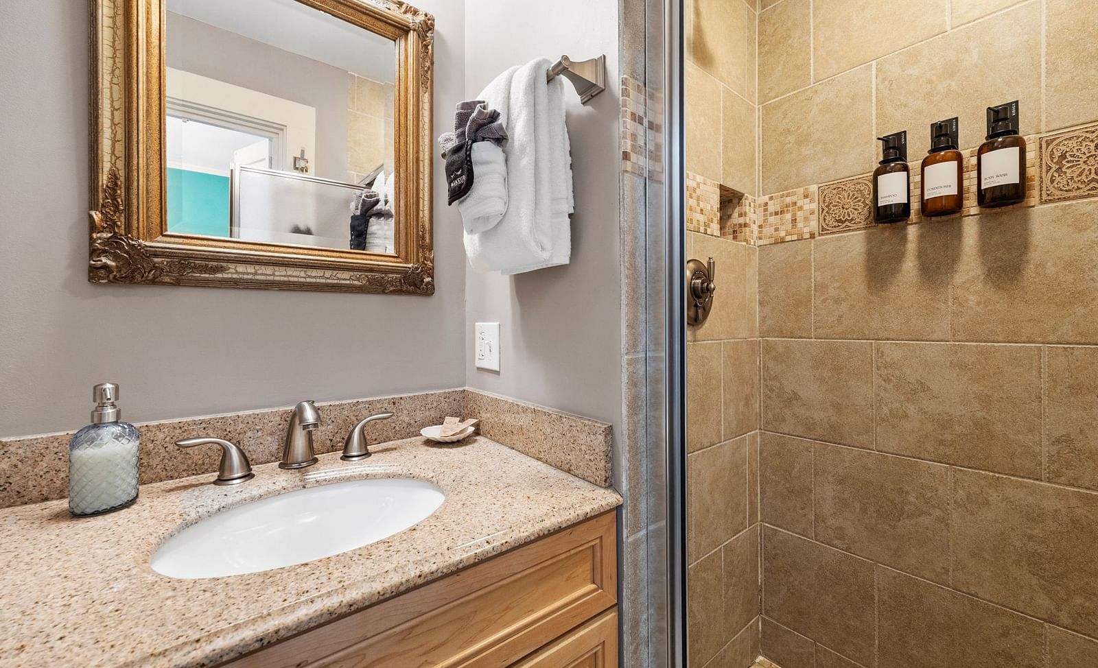 Bathroom with beige granite counter top and shower area at Hartstone Inn