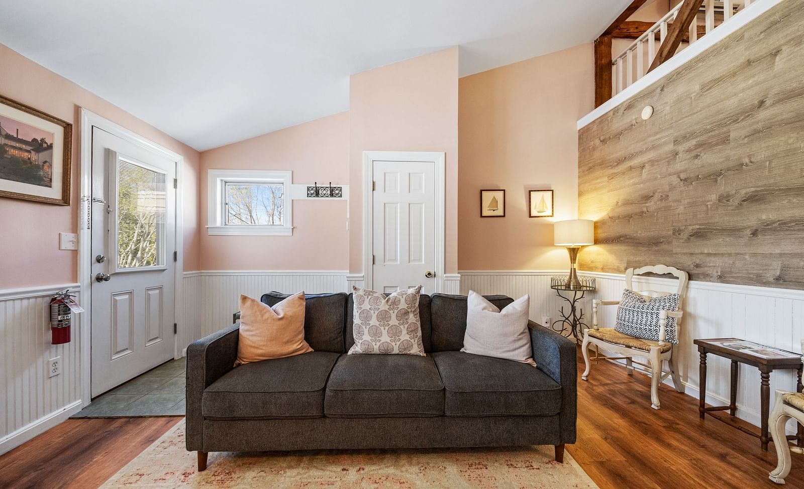 A room with a sitting area, designed cushions, and cozy lighting at Hartstone Inn