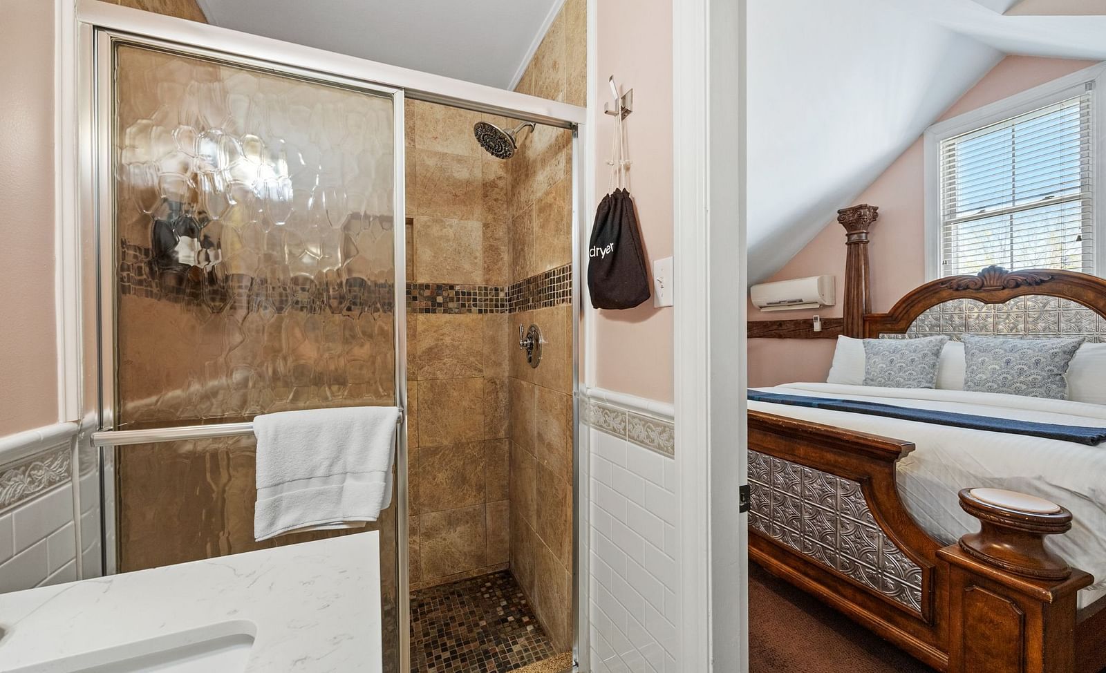  A room with separate shower area, hanging towels, a queen sized bed at Hartstone Inn.