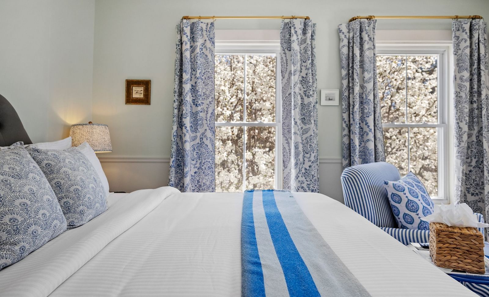 A Room with blue patterned drapes and a seating area in the corner at Hartstone Inn