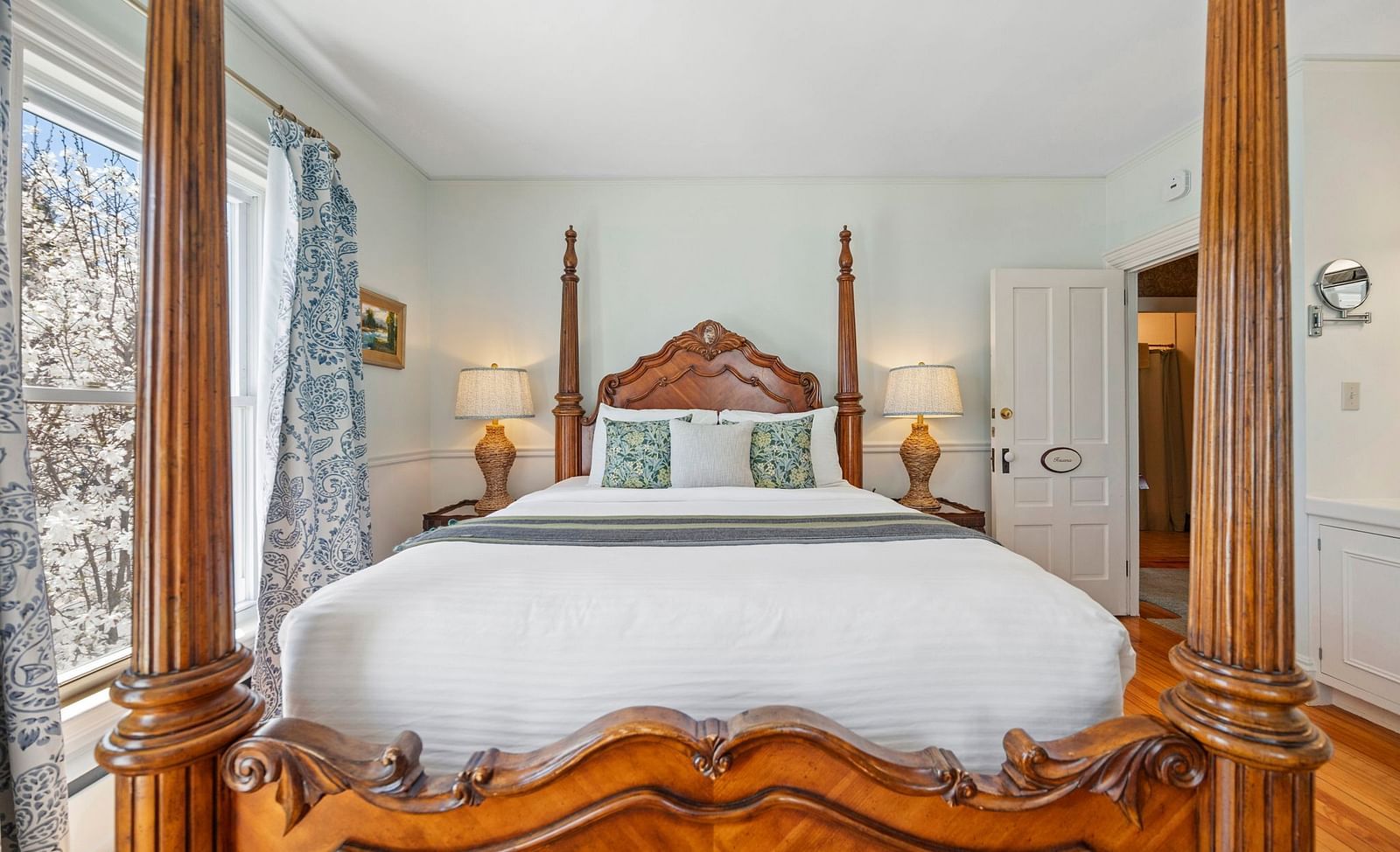 Room with ornate four-poster bed and classic decor at Hartstone Inn.